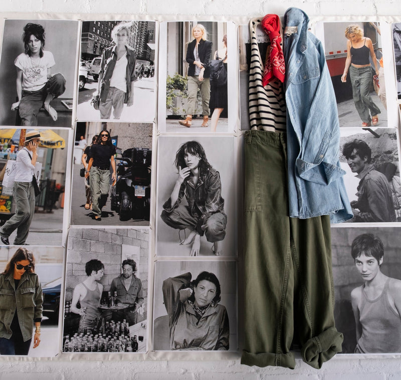 Clothes displayed against a wall of black-and-white fashion photography.