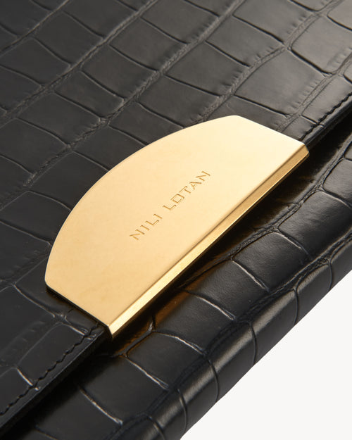 LE AGNES CLUTCH IN BLACK AND GOLD